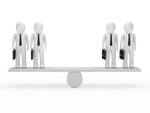 2 white 3D figures standing on each side of perfectly-balanced see-saw