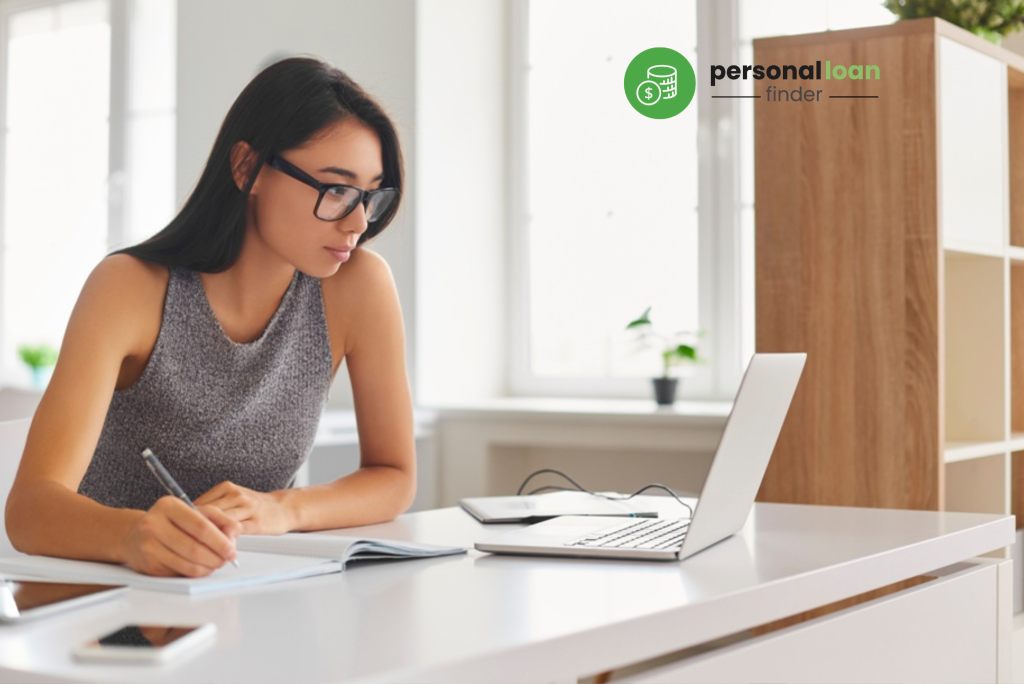 Young lady researching on credit score in Singapore using her laptop, diligently taking down notes on how to check her credit score